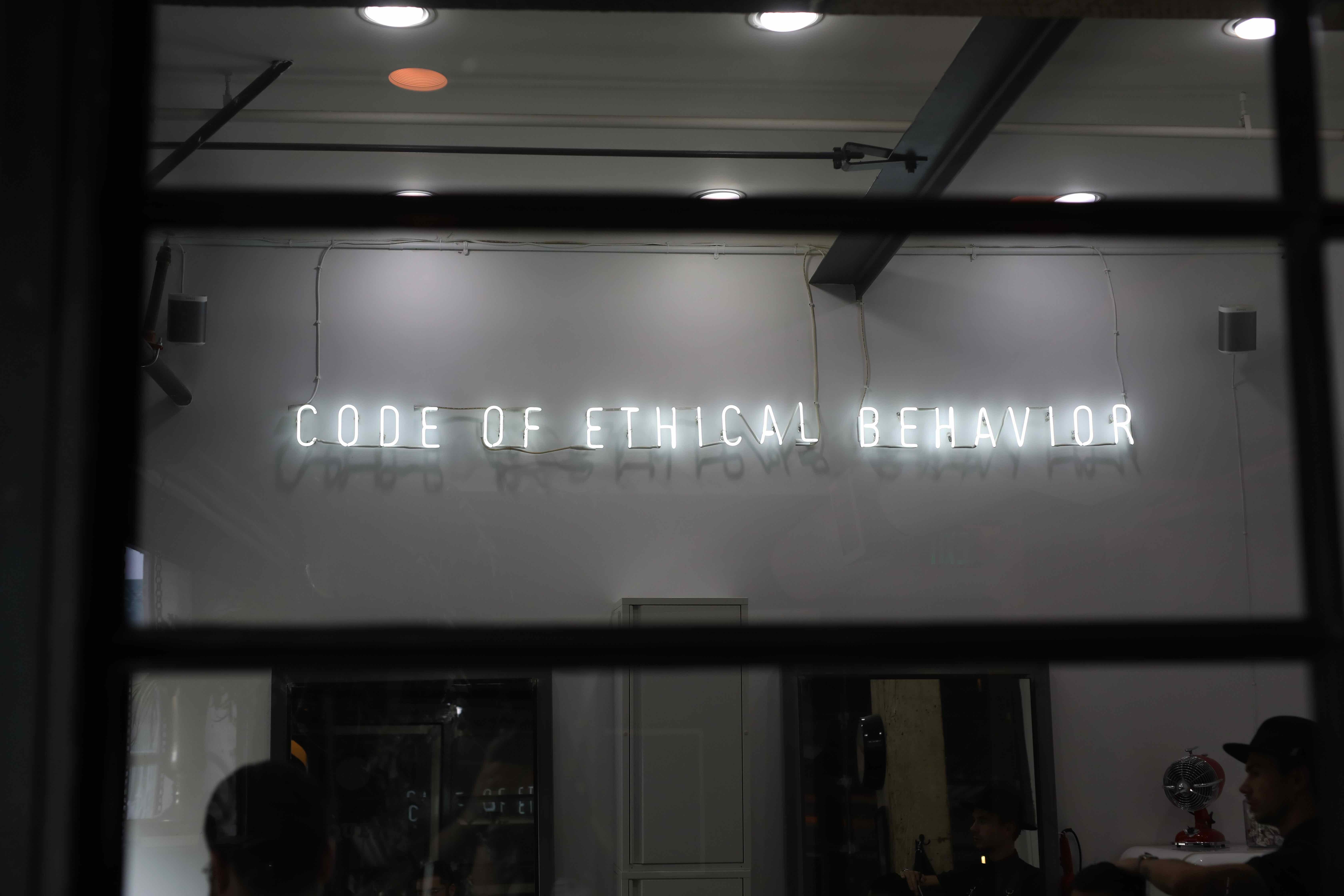 Data ethics. Neon sign saying code of ethical behaviour